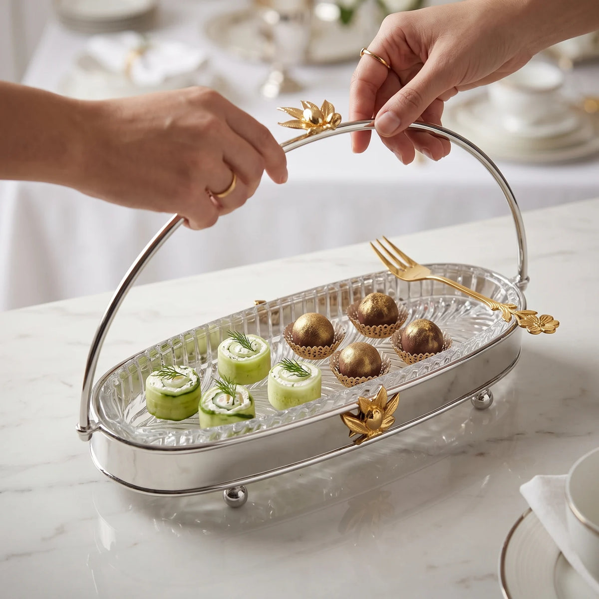 MAY FLOWER Premium Small Oval Serving Tray – Steel & Glass with Arch Handle, Gold-Tone Floral Accent | Decorative Food Display Stand, 24cm H x 14cm W x 34cm L