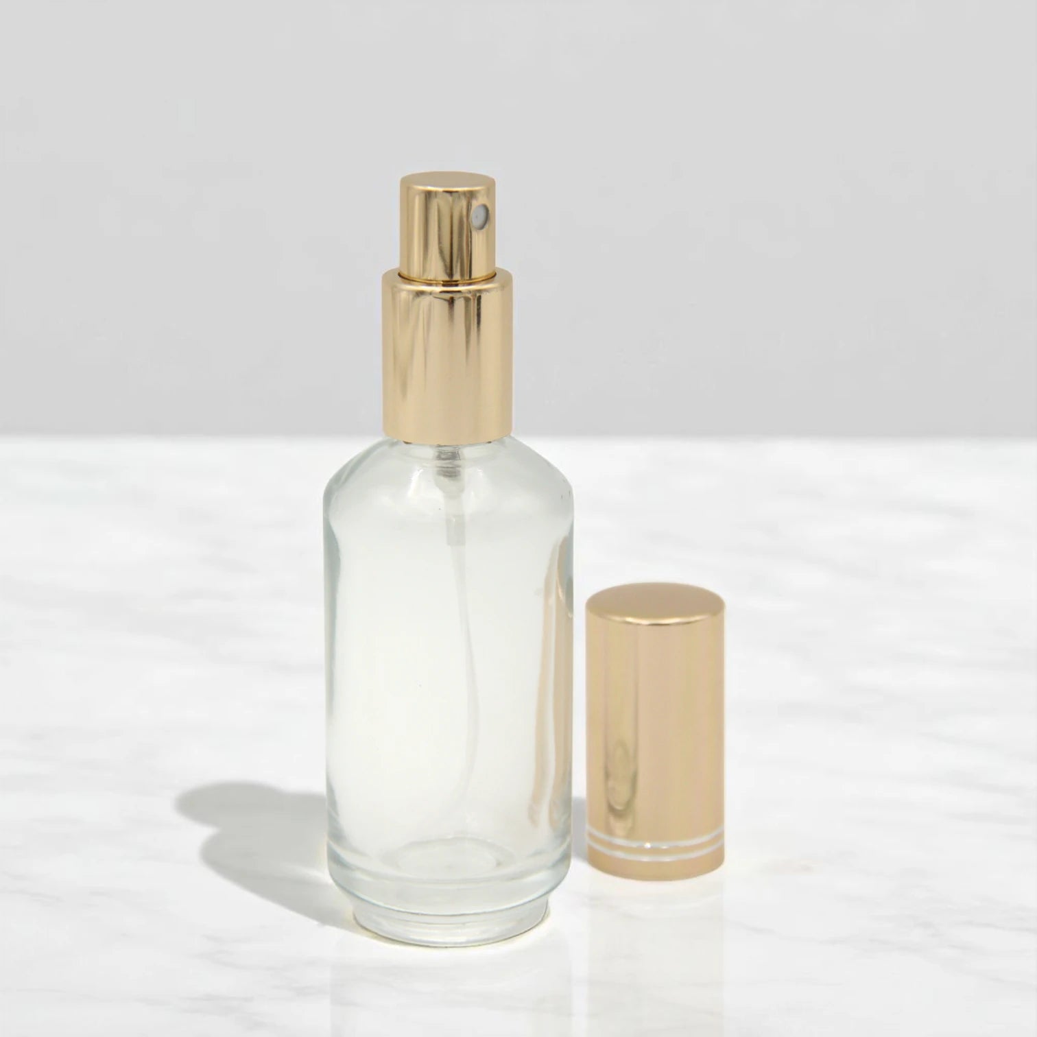 Empty Perfume Bottle 50 ML – Clear Glass Refillable Spray Bottle with Shiny Gold Cap | Portable Atomizer for Perfumes, Essential Oils & Sprays - Damoo
