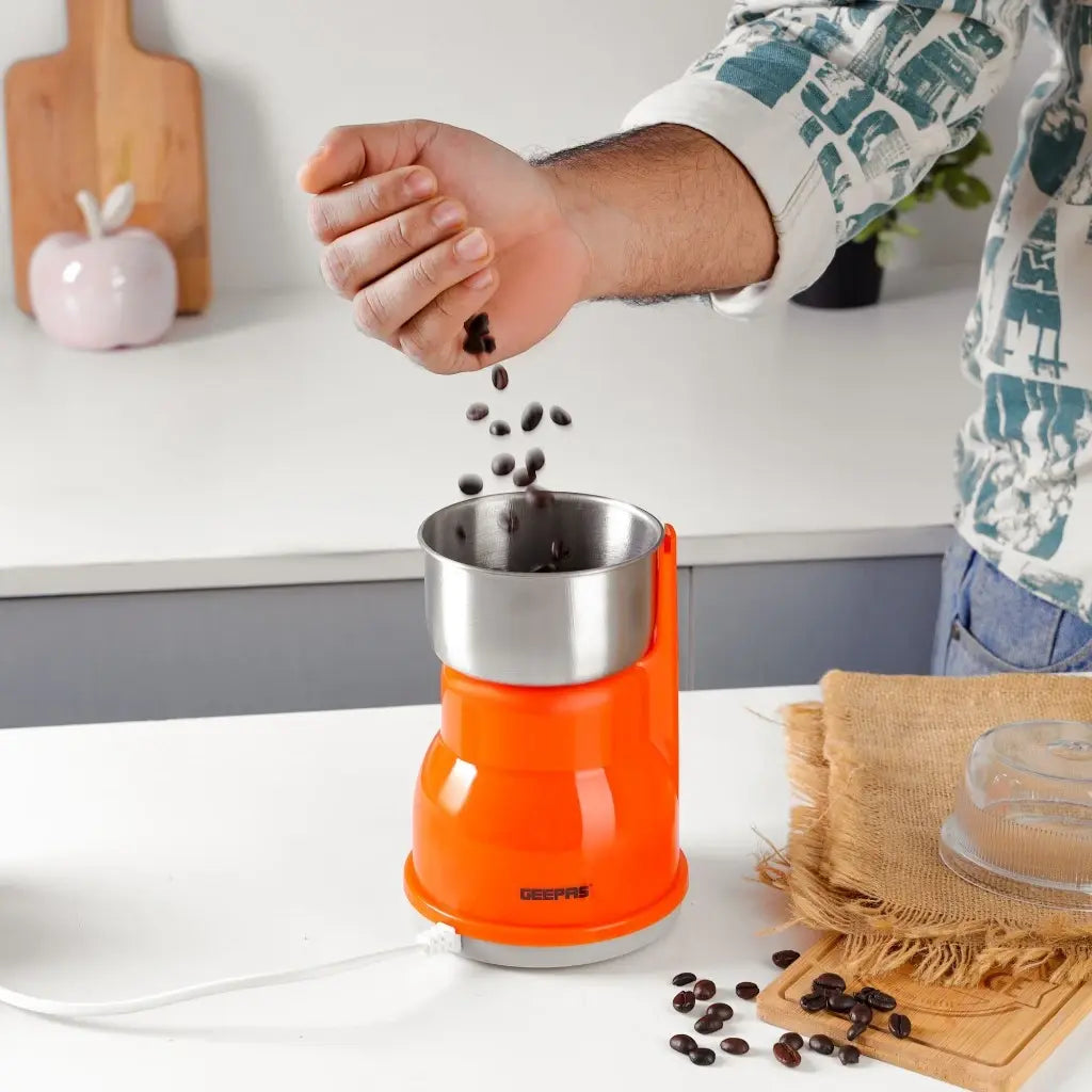 Geepas Electric Coffee Grinder – 300W Powerful Motor with Overheat Protection, Stainless Steel Blades & Bowl | Press-to-Grind Function, 150g Capacity for Coffee Beans, Spices, Nuts & More – GCG5440N – Orange - Damoo