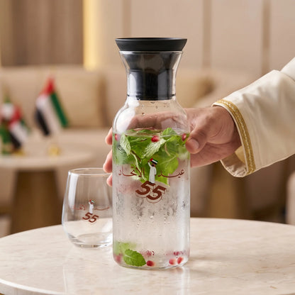 UAE National Day Glass Jug with Airtight Lid – Clear Cylindrical Bottle with Black Stopper, Arabic Decoration and UAE Flag Graphic for Festive Display